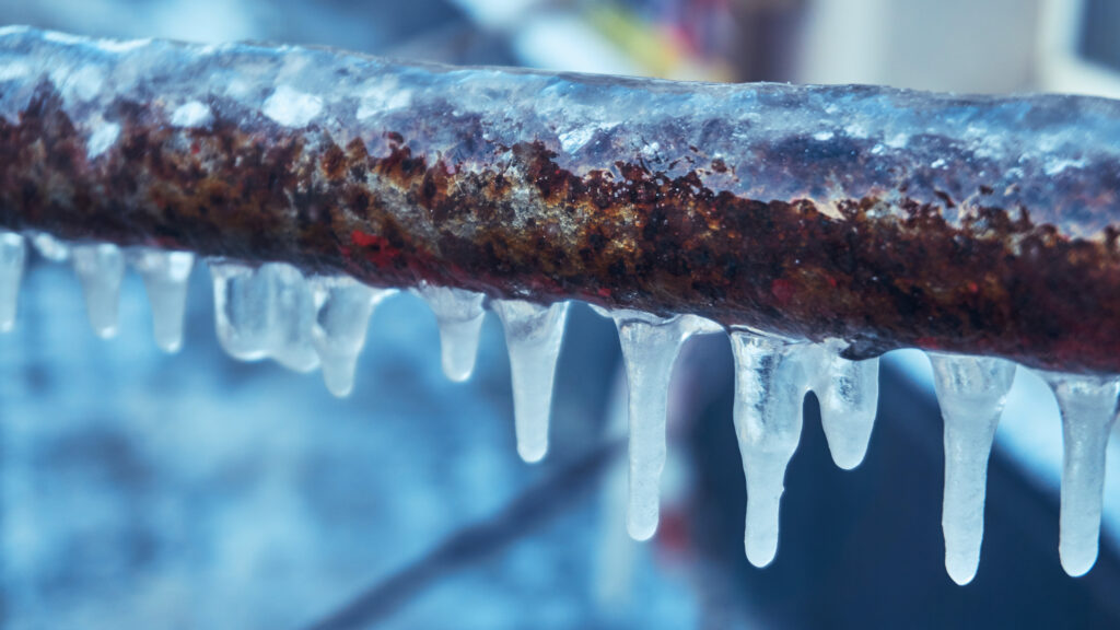 Frozen pipe with icicles forming